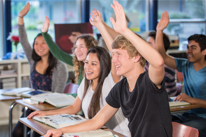 Classroom scene with students raising their hands, smiling, and engaged in a discussion.